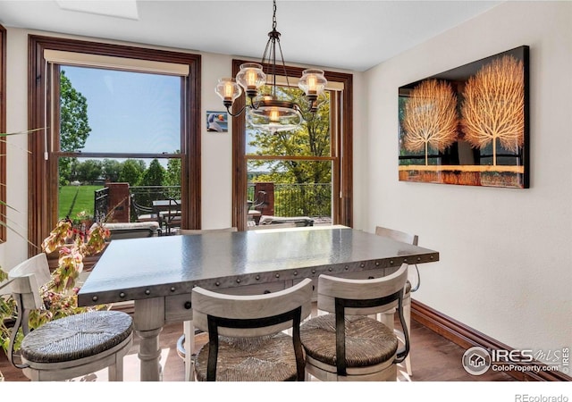 20360 County Road 3, Berthoud, CO 80513 - dining area featuring a chandelier, wood finished floors, and baseboards