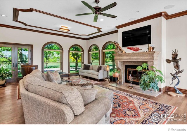 20360 County Road 3, Berthoud, CO 80513 - living room featuring crown molding, ceiling fan, wood finished floors, a fireplace, and french doors