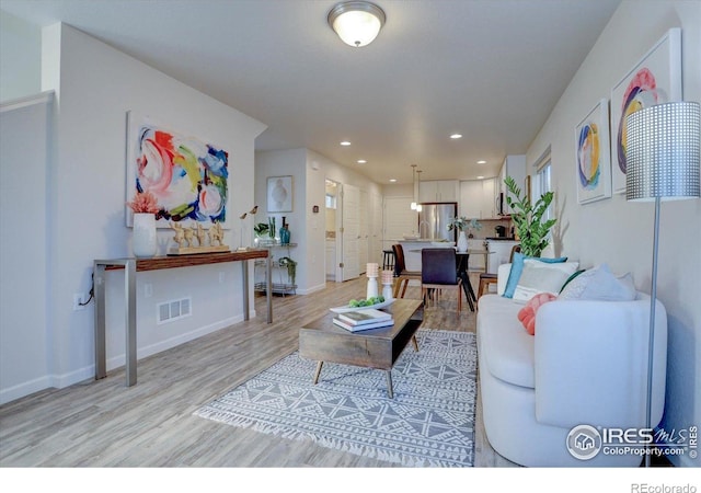 5863 Boston St, Denver, CO 80238 - living room featuring light wood-style flooring, baseboards, and recessed lighting