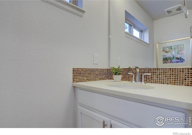 5863 Boston St, Denver, CO 80238 - bathroom featuring backsplash and vanity