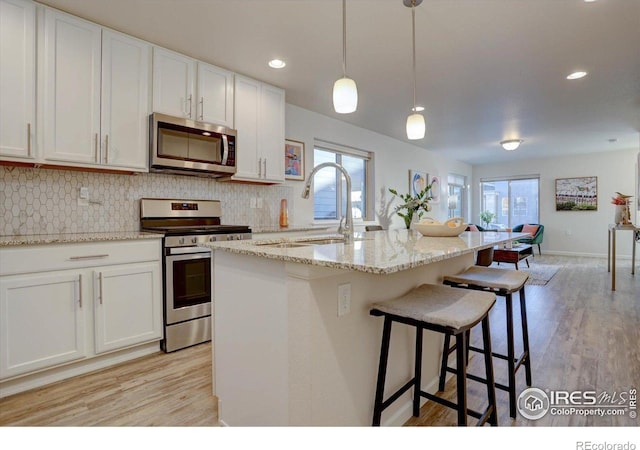 5863 Boston St, Denver, CO 80238 - kitchen with appliances with stainless steel finishes, a sink, plenty of natural light, decorative backsplash, and recessed lighting