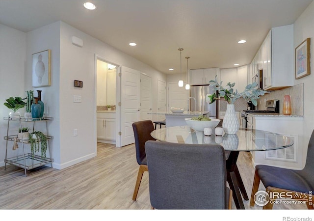 5863 Boston St, Denver, CO 80238 - dining area with light wood-style floors, baseboards, and recessed lighting
