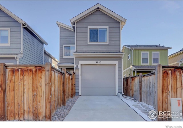 5863 Boston St, Denver, CO 80238 - view of front of home with a garage and driveway