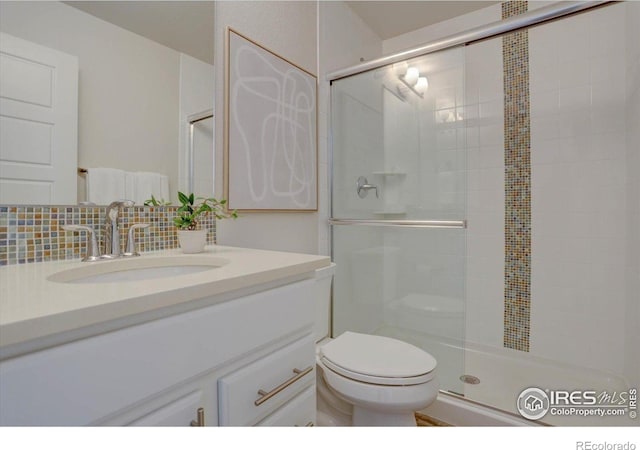 5863 Boston St, Denver, CO 80238 - full bathroom with toilet, vanity, a stall shower, and backsplash