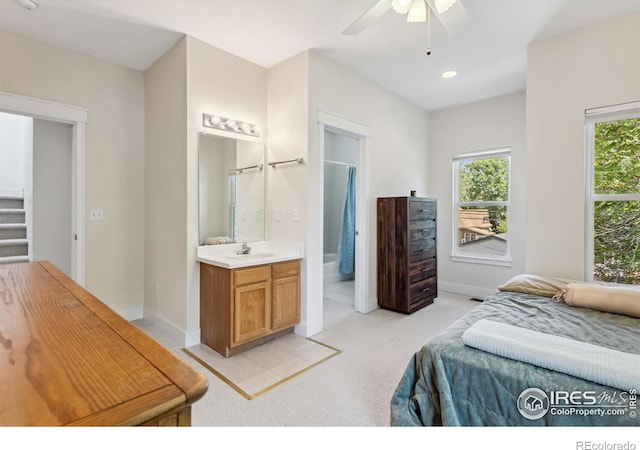 820 Kimbark St Unit D, Longmont, CO 80501 - bedroom featuring light colored carpet, connected bathroom, baseboards, recessed lighting, and a sink