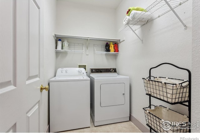 820 Kimbark St Unit D, Longmont, CO 80501 - laundry room with washer and dryer, light tile patterned floors, and baseboards