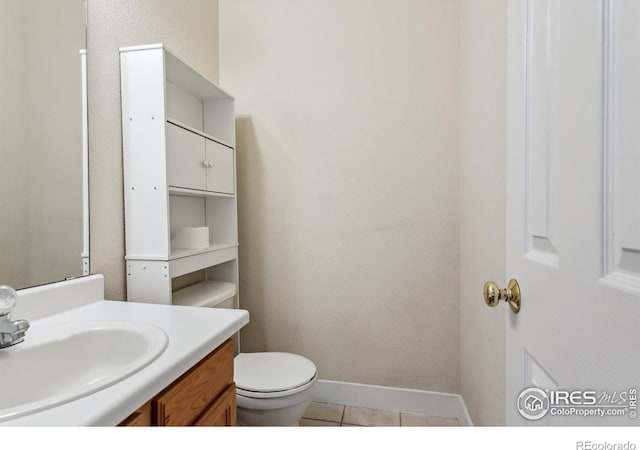 820 Kimbark St Unit D, Longmont, CO 80501 - bathroom featuring vanity, toilet, baseboards, and tile patterned floors