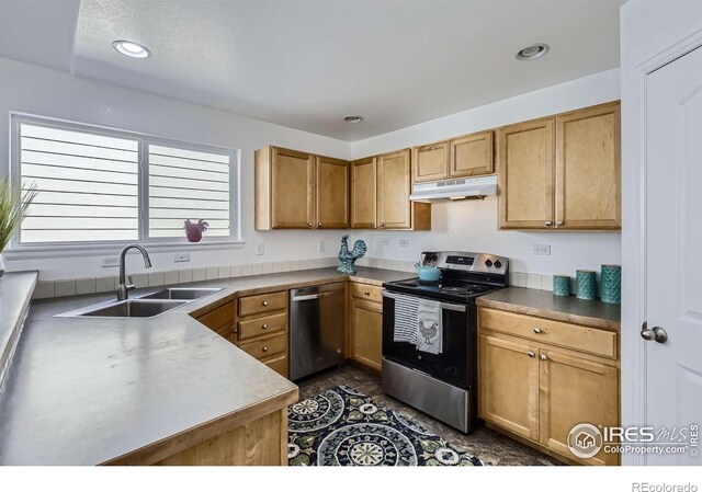2220 Woodbury Ln, Fort Collins, CO 80524 - kitchen with appliances with stainless steel finishes, under cabinet range hood, a sink, recessed lighting, and brown cabinets