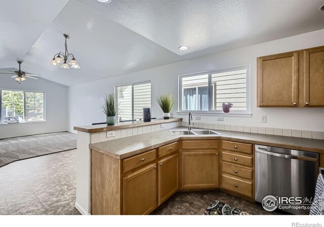 2220 Woodbury Ln, Fort Collins, CO 80524 - kitchen featuring dishwasher, a sink, vaulted ceiling, a peninsula, and brown cabinets