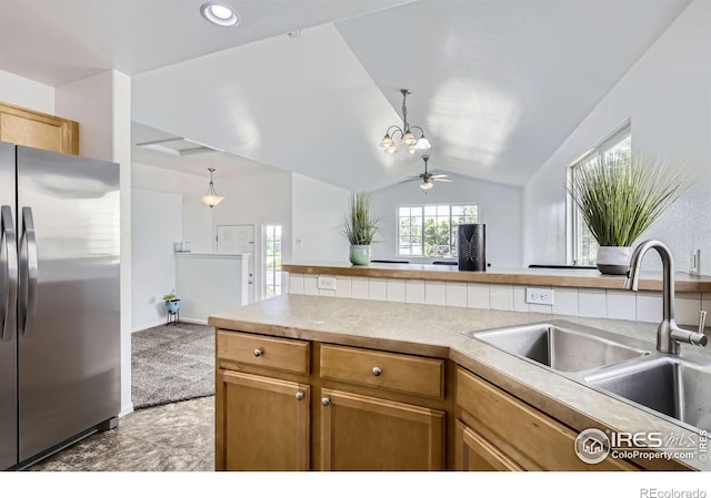 2220 Woodbury Ln, Fort Collins, CO 80524 - kitchen with freestanding refrigerator, a sink, vaulted ceiling, a chandelier, and light countertops