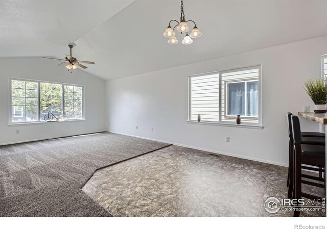 2220 Woodbury Ln, Fort Collins, CO 80524 - unfurnished living room with vaulted ceiling, a ceiling fan, baseboards, and a chandelier