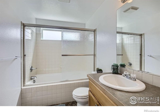 2220 Woodbury Ln, Fort Collins, CO 80524 - full bathroom featuring vanity, toilet, and tiled shower / bath