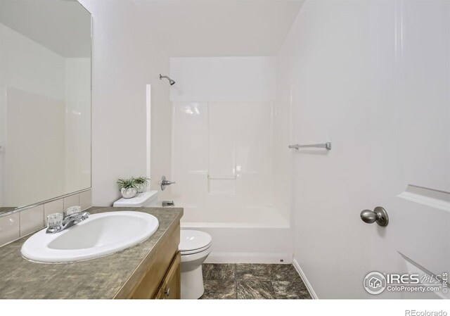 2220 Woodbury Ln, Fort Collins, CO 80524 - bathroom with vanity, toilet, shower / bath combination, and baseboards