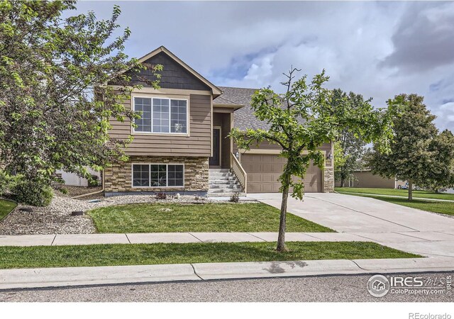 2220 Woodbury Ln, Fort Collins, CO 80524 - view of front of house featuring concrete driveway, a garage, stone siding, and a front yard