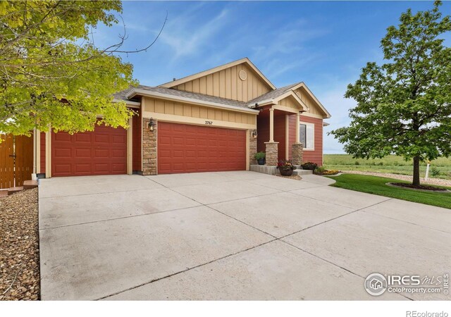 2767 Stallion Way, Mead, CO 80542 - craftsman-style house featuring board and batten siding, a garage, concrete driveway, and stone siding