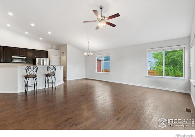 2767 Stallion Way, Mead, CO 80542 - unfurnished living room featuring lofted ceiling, ceiling fan, a chandelier, dark wood-style flooring, and recessed lighting