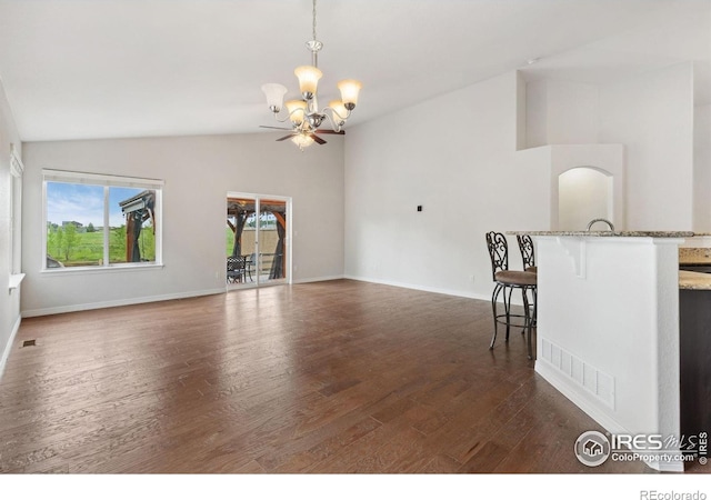 2767 Stallion Way, Mead, CO 80542 - unfurnished living room with vaulted ceiling, a chandelier, dark wood-style floors, and baseboards