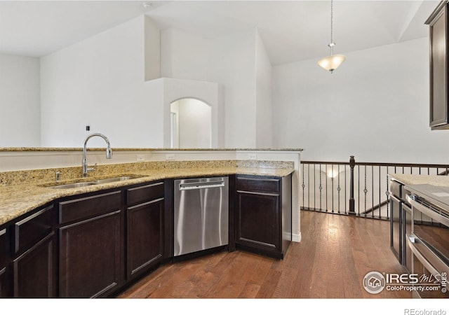 2767 Stallion Way, Mead, CO 80542 - kitchen with appliances with stainless steel finishes, a sink, dark wood finished floors, dark brown cabinets, and light stone countertops