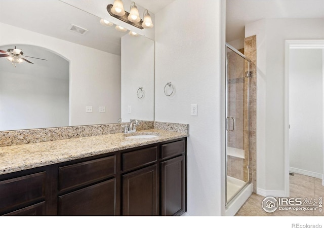 2767 Stallion Way, Mead, CO 80542 - bathroom with a ceiling fan, vanity, a shower stall, tile patterned flooring, and baseboards