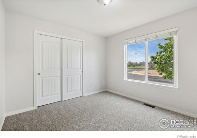 2767 Stallion Way, Mead, CO 80542 - unfurnished bedroom featuring carpet floors, baseboards, and a closet