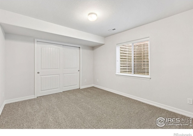 2767 Stallion Way, Mead, CO 80542 - unfurnished bedroom featuring carpet floors, baseboards, and a closet