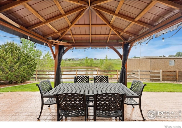2767 Stallion Way, Mead, CO 80542 - view of patio with outdoor dining space, a gazebo, and a water view