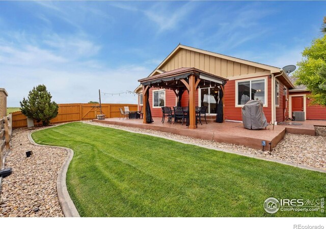 2767 Stallion Way, Mead, CO 80542 - rear view of house with a gazebo, board and batten siding, central AC, and a patio area