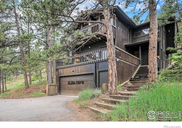335 Wild Horse Cir, Boulder, CO 80304 - view of front of property with stairs, a garage, a balcony, and driveway