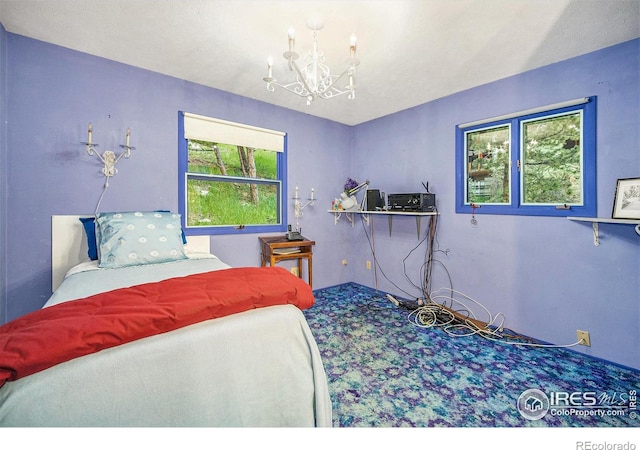335 Wild Horse Cir, Boulder, CO 80304 - carpeted bedroom with a chandelier