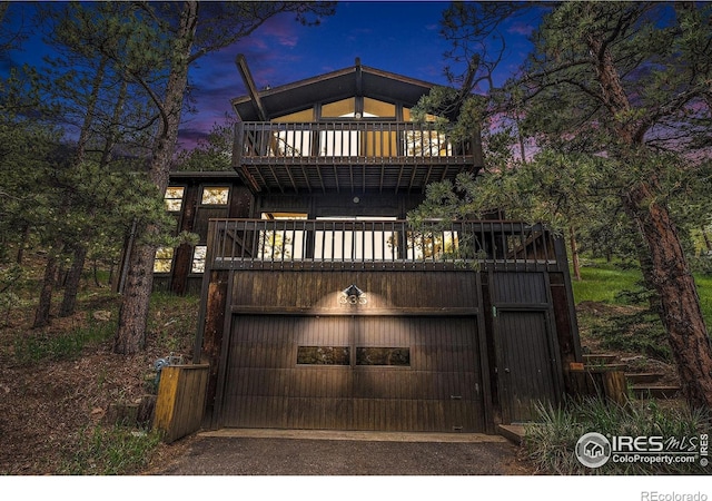 335 Wild Horse Cir, Boulder, CO 80304 - view of front of property with an attached garage, asphalt driveway, and a balcony
