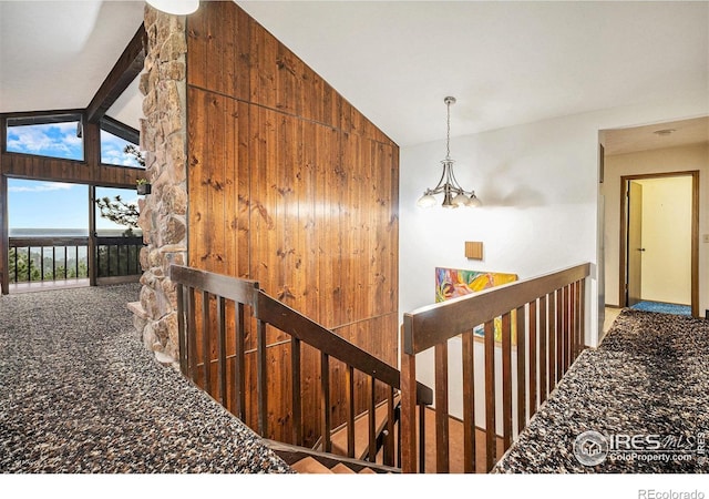 335 Wild Horse Cir, Boulder, CO 80304 - hall featuring vaulted ceiling, an upstairs landing, carpet floors, and a chandelier
