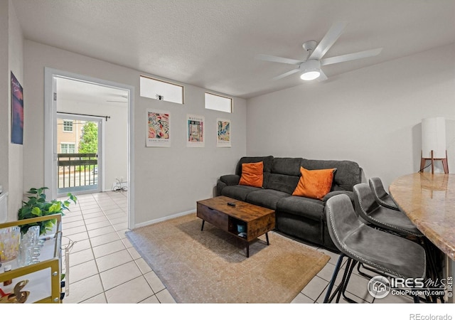 1065 University Ave Unit 121, Boulder, CO 80302 - living area featuring light tile patterned flooring, ceiling fan, and a textured ceiling