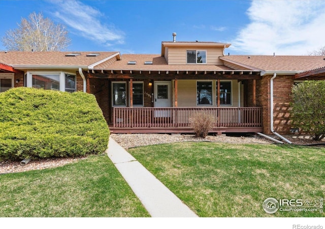1596 W 29th St, Loveland, CO 80538 - view of front of house featuring a front lawn, a porch, brick siding, and roof with shingles
