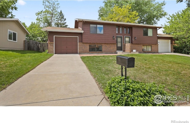517 46th Ave, Greeley, CO 80634 - bi-level home with brick siding, concrete driveway, and a garage