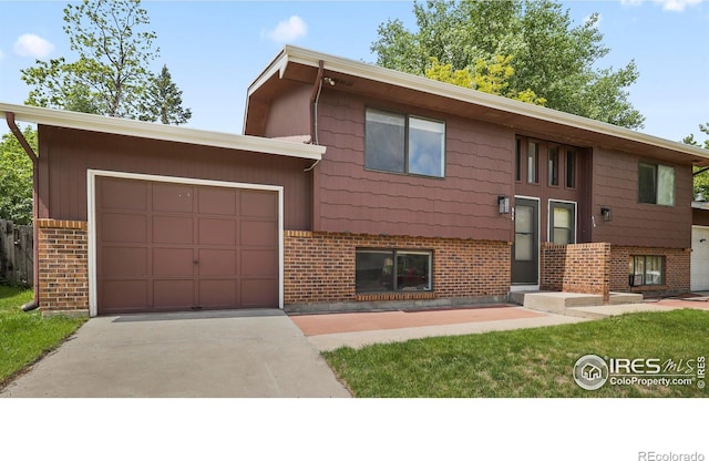 517 46th Ave, Greeley, CO 80634 - bi-level home with brick siding, concrete driveway, and a garage