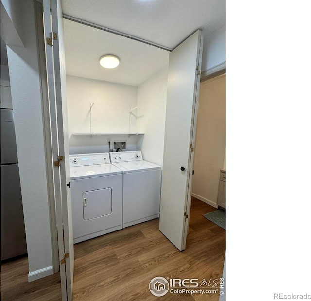 517 46th Ave, Greeley, CO 80634 - laundry area featuring washing machine and dryer, wood finished floors, and baseboards