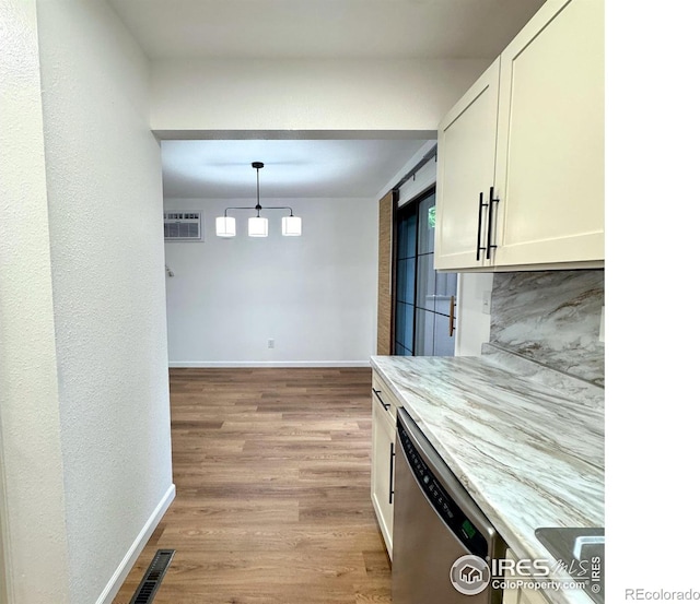 517 46th Ave, Greeley, CO 80634 - kitchen with dishwasher, white cabinets, baseboards, and light wood-style flooring