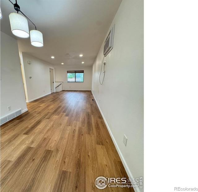 517 46th Ave, Greeley, CO 80634 - spare room with wood finished floors, recessed lighting, baseboards, and a wall unit AC