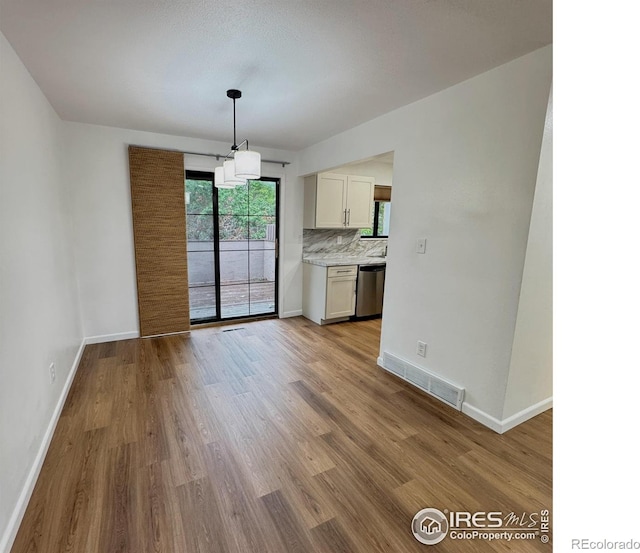 517 46th Ave, Greeley, CO 80634 - unfurnished dining area with baseboards and wood finished floors