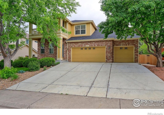 2631 E 136th Pl, Thornton, CO 80602 - view of front of home with driveway, brick siding, a balcony, and roof with shingles