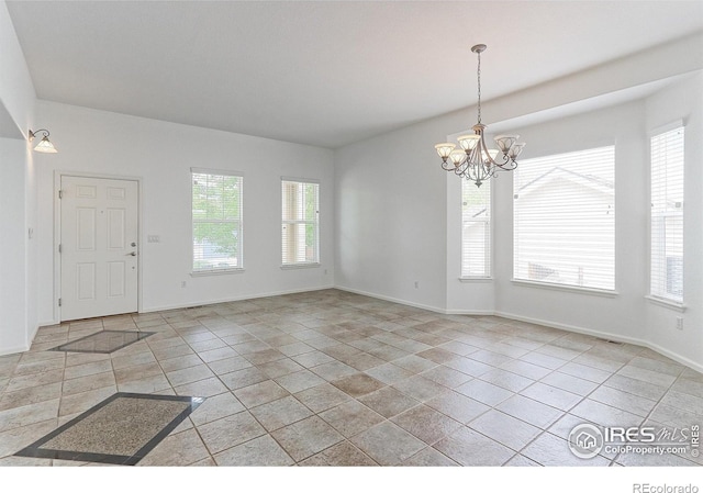 2631 E 136th Pl, Thornton, CO 80602 - spare room featuring a chandelier, baseboards, and light tile patterned floors
