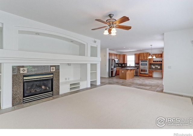 2631 E 136th Pl, Thornton, CO 80602 - living room with light tile patterned flooring, ceiling fan, a tiled fireplace, and built in features