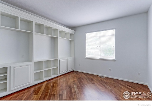 2631 E 136th Pl, Thornton, CO 80602 - spare room with wood finished floors and baseboards
