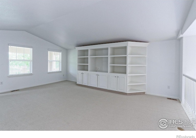 2631 E 136th Pl, Thornton, CO 80602 - spare room with light carpet, lofted ceiling, and baseboards