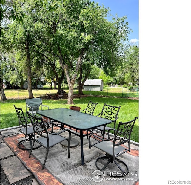 4501 Lawrence Ln, Laporte, CO 80535 - view of patio / terrace featuring outdoor dining space and view of wooded area