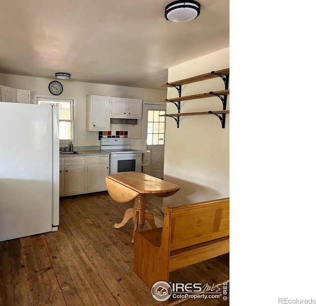 4501 Lawrence Ln, Laporte, CO 80535 - kitchen with white appliances, a sink, dark wood finished floors, white cabinets, and light countertops