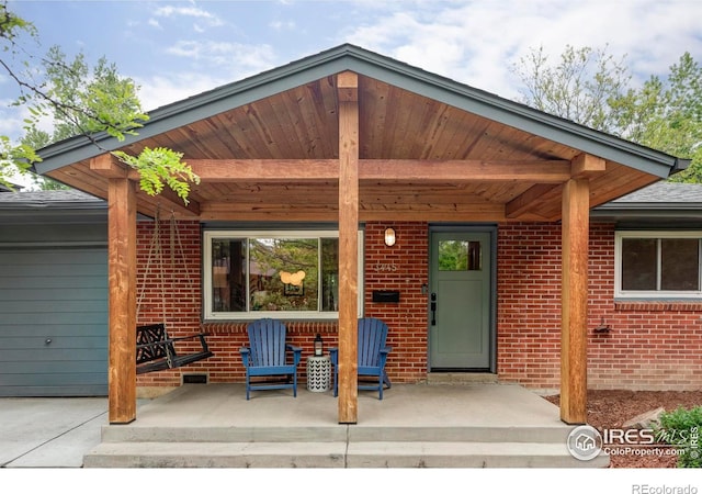 3445 Martin Dr, Boulder, CO 80305 - view of exterior entry featuring brick siding and a porch