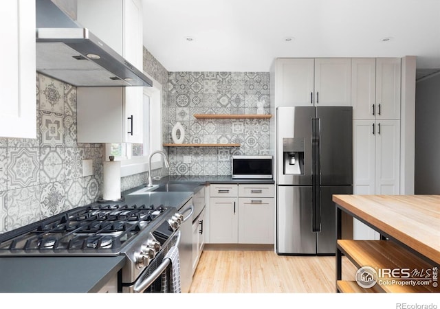 3445 Martin Dr, Boulder, CO 80305 - kitchen with appliances with stainless steel finishes, wall chimney range hood, a sink, open shelves, and backsplash