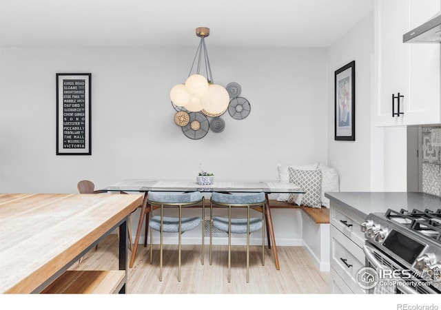 3445 Martin Dr, Boulder, CO 80305 - dining room with breakfast area, light wood finished floors, baseboards, and a chandelier