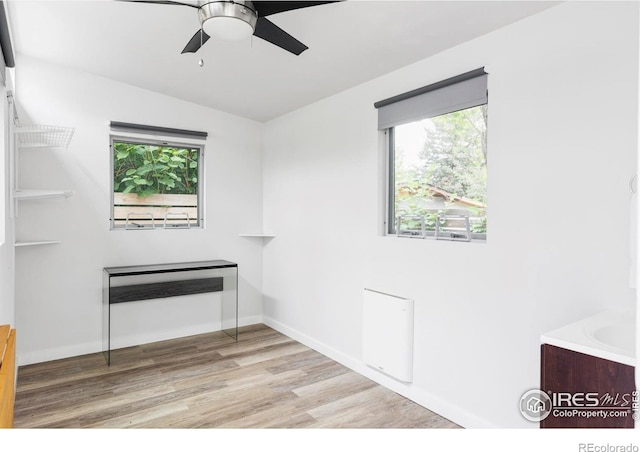 3445 Martin Dr, Boulder, CO 80305 - unfurnished room featuring wood finished floors, plenty of natural light, a ceiling fan, and baseboards